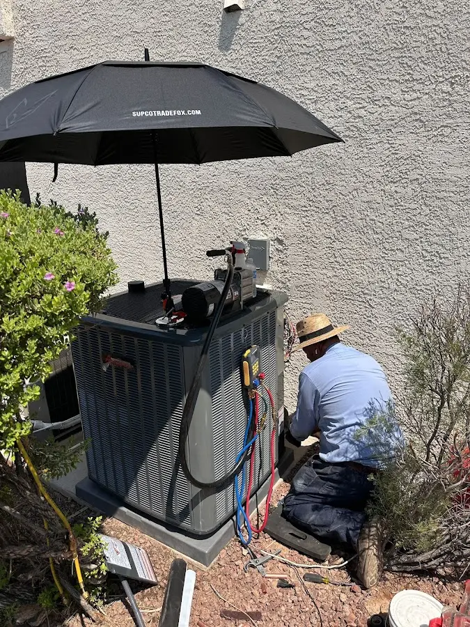HVAC technician performing outdoor AC maintenance in Evesham